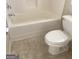 Bathroom featuring a toilet next to a bathtub with tile floor at 460 Ridgewood Dr, Fayetteville, GA 30215