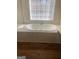 Large soaking tub under a window in the primary bath at 460 Ridgewood Dr, Fayetteville, GA 30215