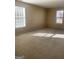 Bright, carpeted bedroom with two windows allowing for plenty of natural light at 460 Ridgewood Dr, Fayetteville, GA 30215