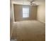 Bright bedroom featuring neutral walls, plush carpeting, and a ceiling fan at 460 Ridgewood Dr, Fayetteville, GA 30215