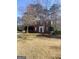 Charming two-story brick home with a well-maintained yard and mature trees in a quiet neighborhood at 460 Ridgewood Dr, Fayetteville, GA 30215