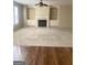 Living room featuring a fireplace, built-in shelving, and hardwood flooring at 460 Ridgewood Dr, Fayetteville, GA 30215