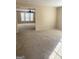 Spacious, carpeted living room with ample natural light and neutral tones at 460 Ridgewood Dr, Fayetteville, GA 30215