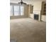 Cozy living room with a fireplace, built-in shelves, and large windows at 460 Ridgewood Dr, Fayetteville, GA 30215