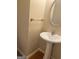 This powder room features a pedestal sink with an oval mirror and a towel bar at 460 Ridgewood Dr, Fayetteville, GA 30215