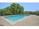 Community pool surrounded by trees and lounge chairs at 2285 Peachtree Rd # 602, Atlanta, GA 30309
