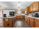 Well-lit kitchen featuring wood cabinetry, black appliances, and a functional kitchen island at 349 Asa Moseley Rd, Stockbridge, GA 30281