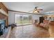 Open living area showcasing stone floors, a ceiling fan, and sliding glass doors to the backyard at 349 Asa Moseley Rd, Stockbridge, GA 30281