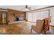 Living room with stone floors, a ceiling fan, a brick fireplace, and furniture at 349 Asa Moseley Rd, Stockbridge, GA 30281