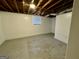 Unfinished basement with exposed ductwork and small window at 791 Gertrude Nw Pl, Atlanta, GA 30318