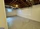 Unfinished basement area with concrete floor, exposed ceiling, and small window at 791 Gertrude Nw Pl, Atlanta, GA 30318