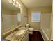 Bathroom features a granite countertop, large mirror, and a combined tub and shower at 791 Gertrude Nw Pl, Atlanta, GA 30318
