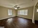 Bright bedroom with dark floors features windows offering natural light and modern ceiling fan at 791 Gertrude Nw Pl, Atlanta, GA 30318