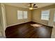Bright bedroom with hardwood floors, a ceiling fan, and two windows at 791 Gertrude Nw Pl, Atlanta, GA 30318