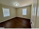 A cozy bedroom features dark wood floors and a bright window with a view of the outdoors at 791 Gertrude Nw Pl, Atlanta, GA 30318