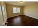 Bright bedroom with dark floors features a window offering natural light at 791 Gertrude Nw Pl, Atlanta, GA 30318