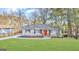 Charming single-story home boasts a well-manicured lawn and a vibrant red front door at 791 Gertrude Nw Pl, Atlanta, GA 30318
