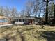 Charming single-story home boasts a well-manicured lawn and mature trees providing shade at 791 Gertrude Nw Pl, Atlanta, GA 30318
