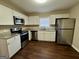 Modern kitchen features stainless steel appliances, granite countertops, and ample cabinet space at 791 Gertrude Nw Pl, Atlanta, GA 30318