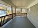 Covered porch with gray painted brick and wood railing at 791 Gertrude Nw Pl, Atlanta, GA 30318