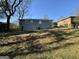 Backyard view of the property with green grass and a fence, plus the rear exterior of the home at 2690 Rollingwood Se Ln, Atlanta, GA 30316