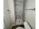Modern bathroom featuring updated shower with stone tile and new fixture at 2690 Rollingwood Se Ln, Atlanta, GA 30316