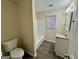 Cozy bathroom with tiled shower and tub combination, updated vanity with granite countertop, and wood-look flooring at 6380 Phillips Pl, Lithonia, GA 30058