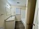 Clean bathroom with granite vanity, tub-shower combo, and vinyl plank flooring at 6380 Phillips Pl, Lithonia, GA 30058