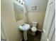 Cozy bathroom with a pedestal sink, toilet, and wood-look flooring at 6380 Phillips Pl, Lithonia, GA 30058