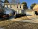 Charming two-story home with a well-maintained front yard and attached two-car garage at 6380 Phillips Pl, Lithonia, GA 30058