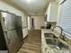 Well-lit kitchen with stainless steel appliances, granite countertops, and a double sink at 6380 Phillips Pl, Lithonia, GA 30058