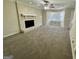 Spacious living room with plush carpet, a large brick fireplace, and a bay window at 6380 Phillips Pl, Lithonia, GA 30058