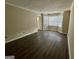 Living room with wood-look flooring, trim and a large window at 6380 Phillips Pl, Lithonia, GA 30058