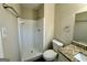 Neutral bathroom featuring a standing shower with a white tiled surround, toilet, and granite countertop vanity at 1965 Rollingwood Se Dr, Atlanta, GA 30316