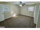 Cozy carpeted bedroom with neutral colors, ceiling fan, and two windows offering plenty of natural light at 1965 Rollingwood Se Dr, Atlanta, GA 30316