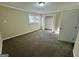 This bedroom features neutral-colored walls, plush carpet, a large window providing ample light, and a closet space at 1965 Rollingwood Se Dr, Atlanta, GA 30316