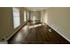 Living room featuring wood vinyl flooring, neutral-colored walls and multiple large windows providing natural light at 1965 Rollingwood Se Dr, Atlanta, GA 30316