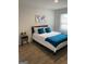 Bedroom with ample natural light, wooden flooring, and a bed with stylish blue pillows at 742 Great Oak Pl # 13, Villa Rica, GA 30180