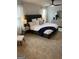 Well-lit bedroom featuring a ceiling fan, comfortable bed, and dresser with a decorative mirror at 742 Great Oak Pl # 13, Villa Rica, GA 30180