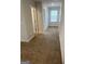 Well-lit hallway with plush carpeting, showcasing access to various rooms at 742 Great Oak Pl # 13, Villa Rica, GA 30180