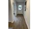 Inviting hallway with wood floors, white trim, and a door with a wreath, leading to other rooms at 742 Great Oak Pl # 13, Villa Rica, GA 30180