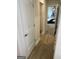 Hallway with wooden flooring leading to a bedroom featuring a bed and dresser at 742 Great Oak Pl # 13, Villa Rica, GA 30180