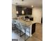 Stylish kitchen featuring a breakfast bar with pendant lighting, dark cabinets, and modern appliances at 742 Great Oak Pl # 13, Villa Rica, GA 30180