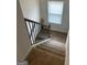 Carpeted staircase with a black metal railing and white trim, lit by a window at 742 Great Oak Pl # 13, Villa Rica, GA 30180