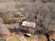 A serene aerial view reveals a charming home nestled among mature trees, showcasing its private and wooded setting at 1225 Pitts Chapel E, Newborn, GA 30056