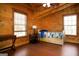 Comfortable bedroom with natural wood and ample natural light from two large windows at 1225 Pitts Chapel E, Newborn, GA 30056