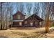 Charming log cabin home featuring a covered front porch and well-maintained landscaping at 1225 Pitts Chapel E, Newborn, GA 30056