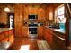 Well-equipped kitchen with stainless steel appliances, custom cabinets, hardwood floors, and a bright window at 1225 Pitts Chapel E, Newborn, GA 30056