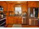 This kitchen has stainless steel appliances and wood cabinets, complemented by a window and coordinating backsplash at 1225 Pitts Chapel E, Newborn, GA 30056