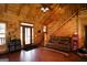 Spacious living room features hardwood floors, a staircase to the second floor, and comfortable leather seating at 1225 Pitts Chapel E, Newborn, GA 30056